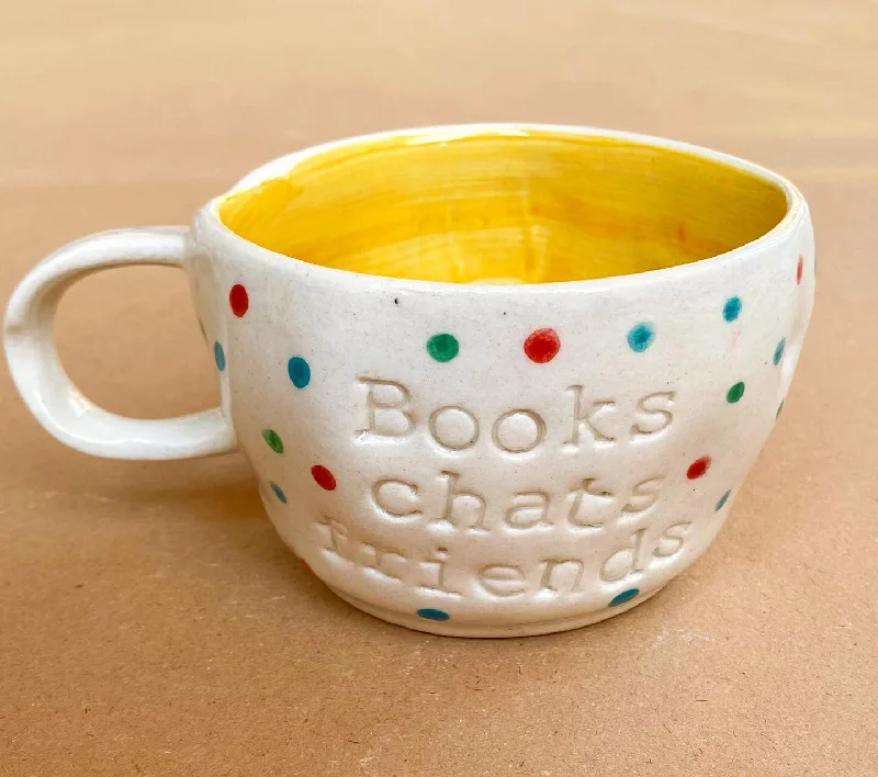 Trendy oversized ceramic tumblers-Books chats friends wobby mug in yellow. These mugs are hand built so each mug will be different in its crookedness and wobbliness. No two are the same.