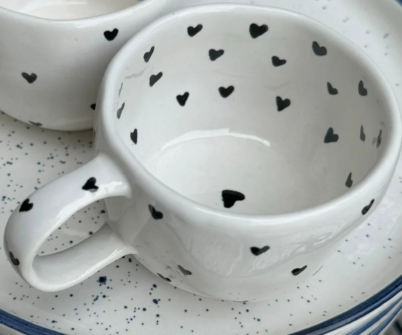 Stylish glass mugs for coffee-Tiny black hearts on cream wobbly mug.